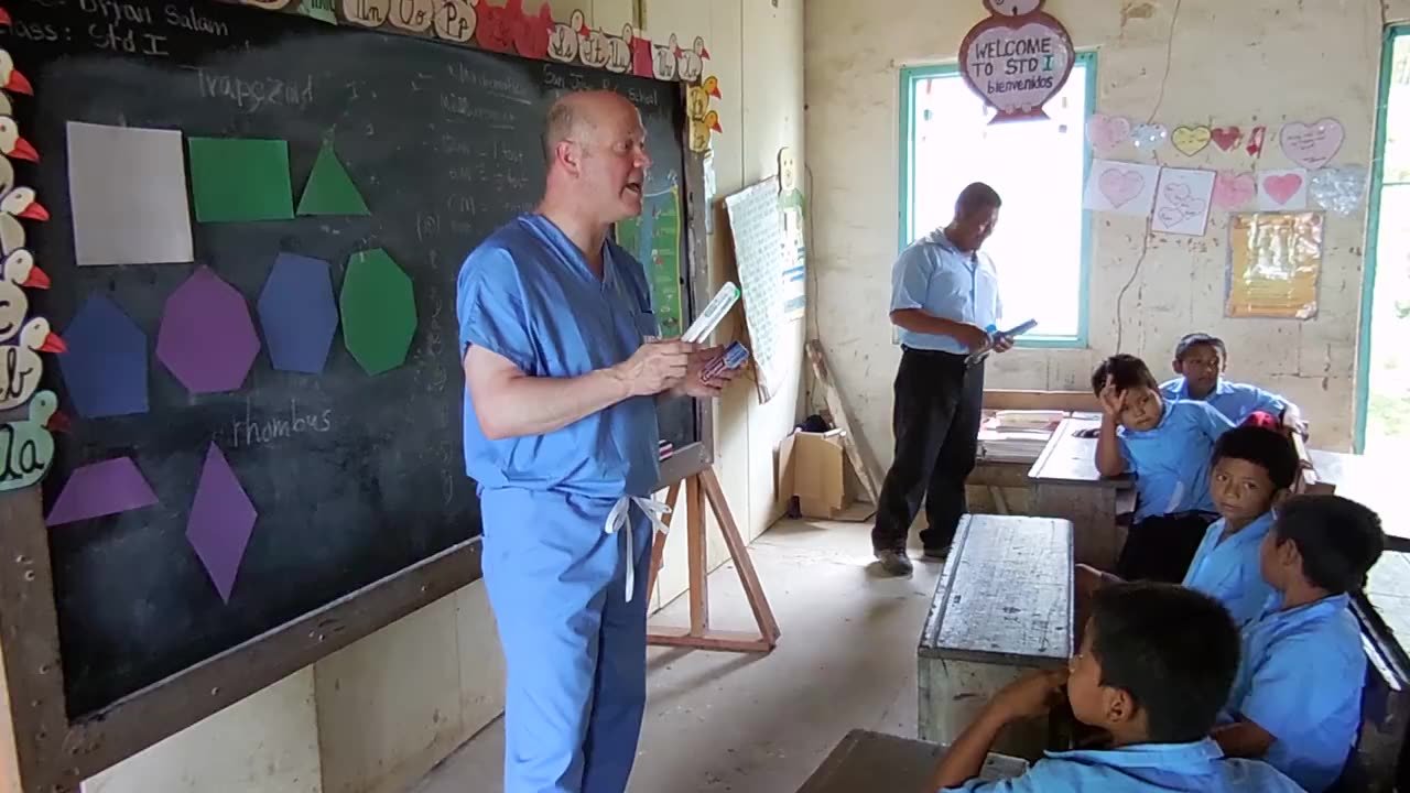 Dr. Douglas Smail teaching dental health to children during a Smiles Bring Hope mission classroom visit