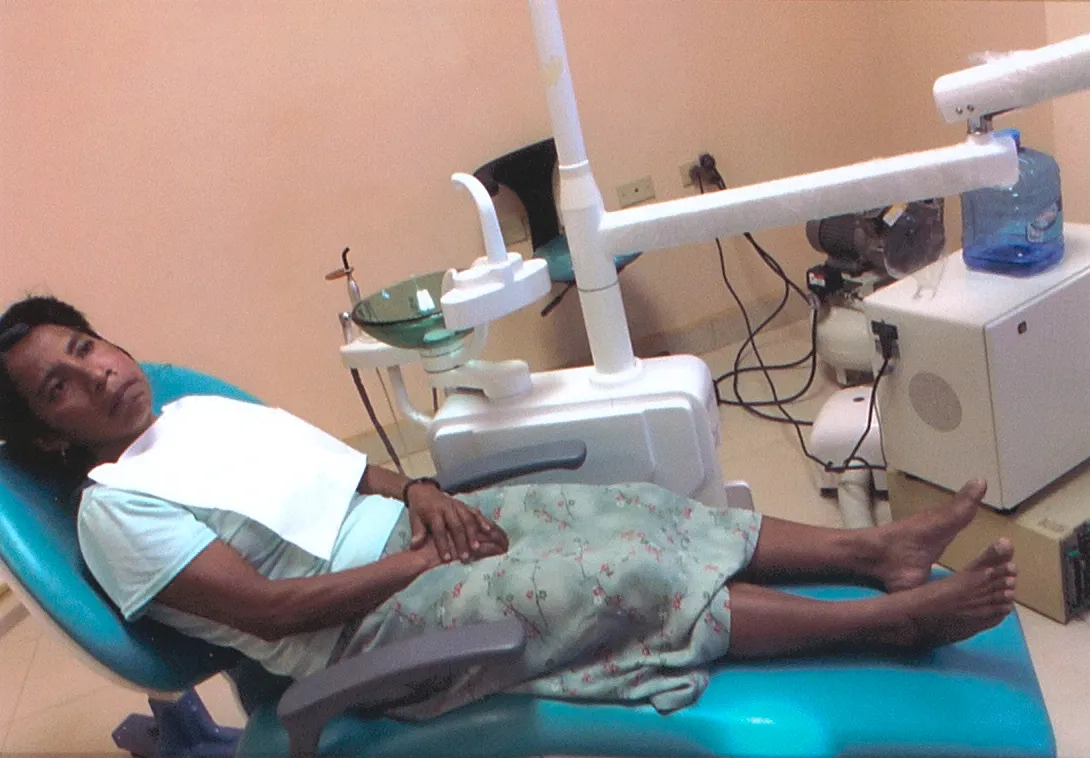 Smiles Bring Hope clinician providing dental care to a young patient during a community mission
