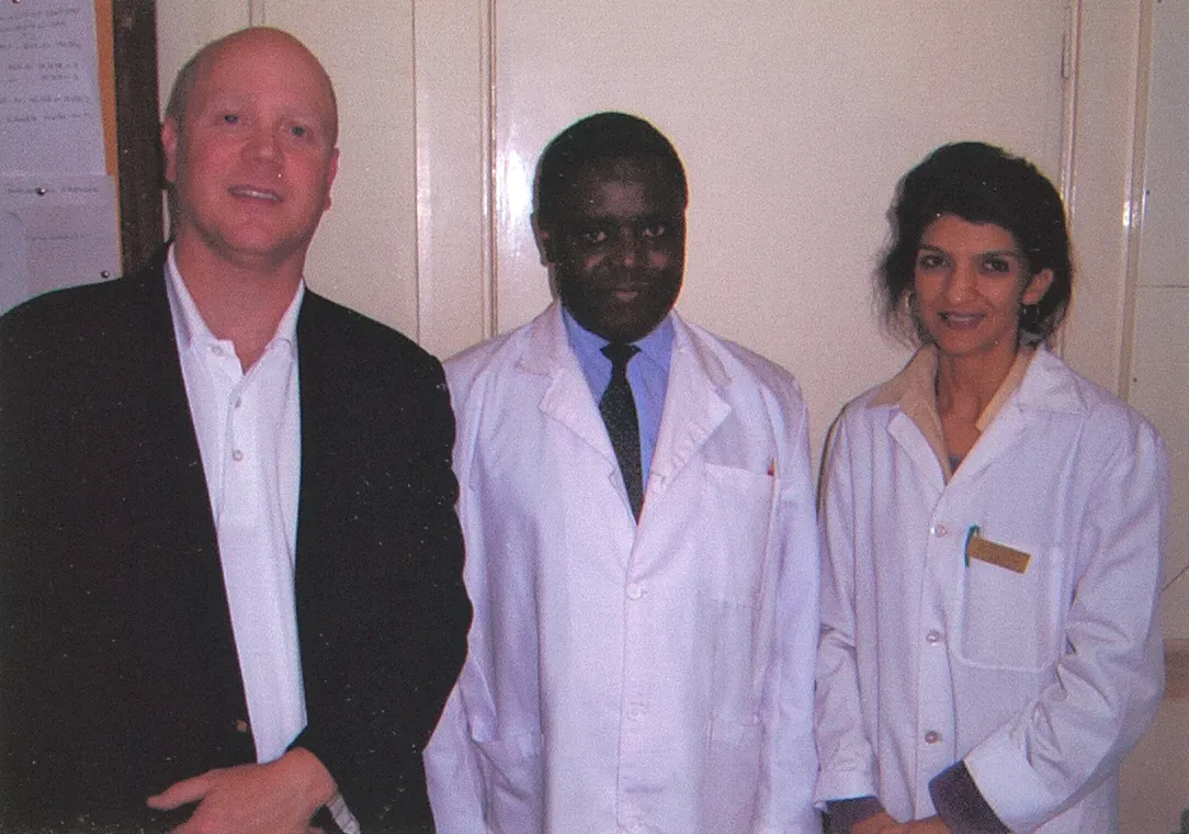 Smiles Bring Hope clinicians standing with a local medical colleague in white coats during a free medical camp in Kenya